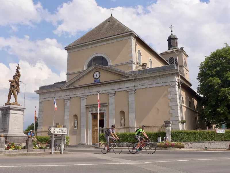 Cyclistes devant l'Église Saint-Jean-Baptiste de Taninges
